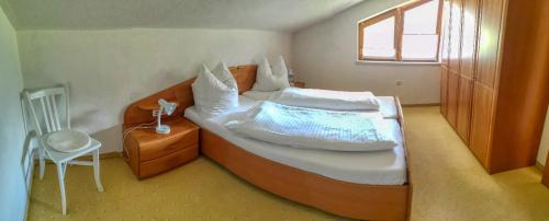 a bedroom with a large white bed with a window at Haus Gerda in Biberwier