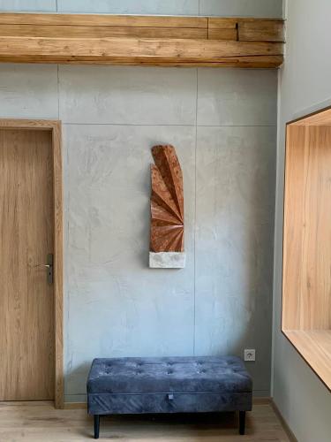 a blue bench in a room next to a wall at Loft Pihenő és Wellness Ház in Balatonfüred