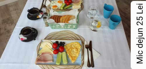 a table with two plates of food on it at Vila PANORAMIC Busteni in Buşteni