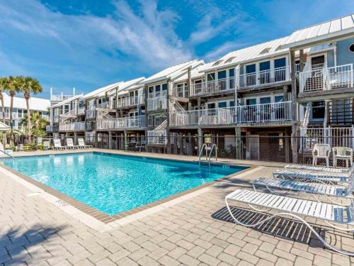 a swimming pool in front of a apartment building at La Bahia #125 in Pensacola Beach