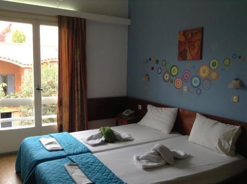 Postel nebo postele na pokoji v ubytování Pasiphae Heraklion Hotel