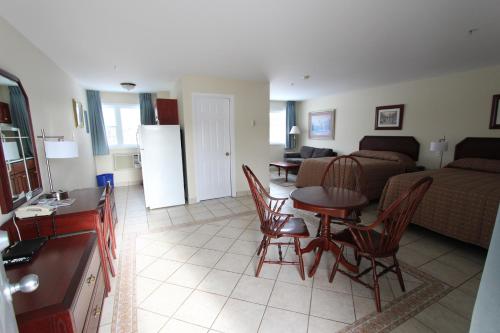 a living room with a couch and a table and chairs at Stardust Motel - Timberlea in Timberlea