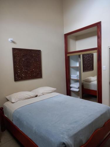 a bedroom with a large bed and a mirror at Ella's Park View Townhouse Crown Point in Crown Point