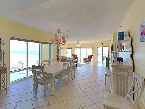 a dining room and living room with a table and chairs at Emerald Isle #401 in Pensacola Beach