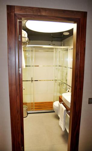 a bathroom with a toilet and a sink at Avin Hotel in Izmir