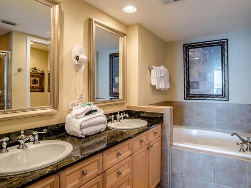 a bathroom with two sinks and a bath tub at Portofino Island Resort #4-1309 in Pensacola Beach