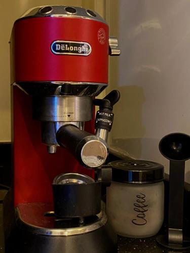 a red coffee machine sitting on top of a counter at Hyat Apartments in Alexandria