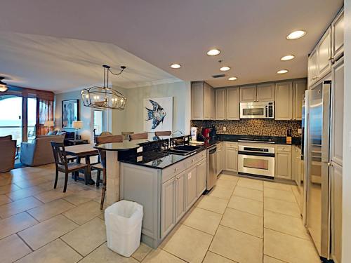 a large kitchen with a table and a dining room at Portofino Island Resort #1-702 in Pensacola Beach