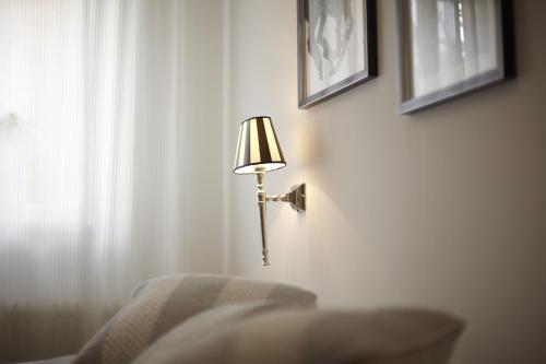 a lamp on a wall next to a chair at Villa Delange in Landau in der Pfalz