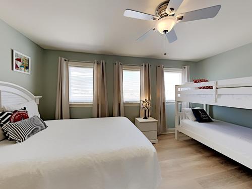 a bedroom with a white bed and a ceiling fan at Dory #E in Perdido Key