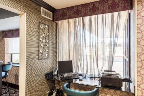 a room with a desk with a computer and a window at Comfort Inn Tulsa Midtown in Tulsa