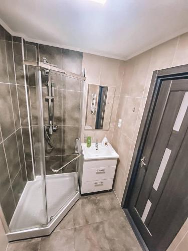 a bathroom with a shower and a sink at Lovely Apartment in Sectorul Botanica