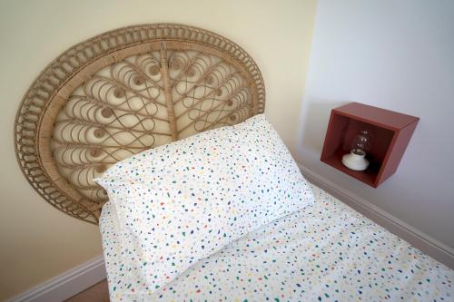 a bed with a wooden head board with a pillow at Beautiful Family Home in the Heart of Swansea in Swansea