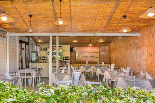 a dining room with tables and chairs in a building at Hotel Ambra in Forte dei Marmi