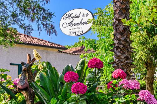 a sign for a garden with pink flowers at Hotel Ambra in Forte dei Marmi