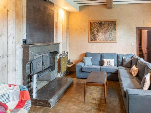 a living room with a couch and a fireplace at Holiday home in Melreux-Hotton with sauna in Melreux