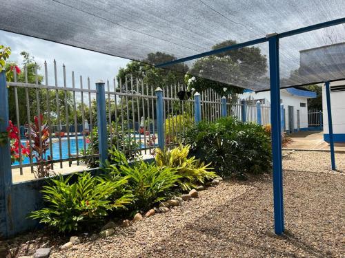 a fence in front of a pool with plants at Hotel campestre la Maria in Villavicencio
