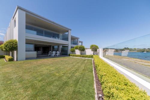 an exterior view of a house with a large yard at Sacred Waters Taupo in Taupo