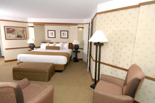 a hotel room with a bed and two chairs at Bally's Atlantic City Hotel & Casino in Atlantic City