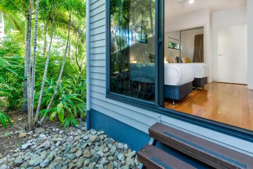 a bedroom with a view of a bed and a window at Pinnacle Apartments on Hamilton Island by HIHA in Hamilton Island