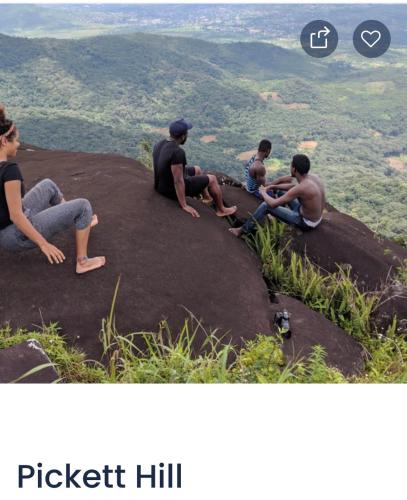 a group of people sitting on top of a mountain at HOTEL MALLIKA COMPANY, SL in Freetown