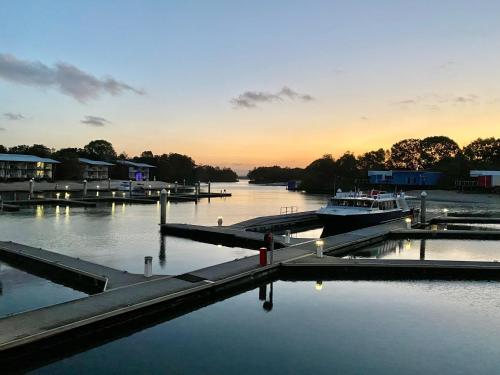 a boat is docked at a dock in a river at Couran Cove Resort Private Apartments, South Stradbroke Island, Gold Coast in South Stradbroke