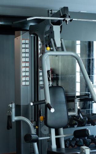 a gym with a chair in a room at karaarom hotel in Bangkok