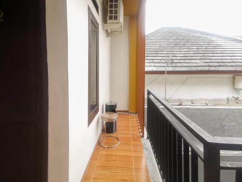 a balcony with a trash can sitting on the floor at RedDoorz @ Jalan Urip Sumoharjo Lampung in Kedaton