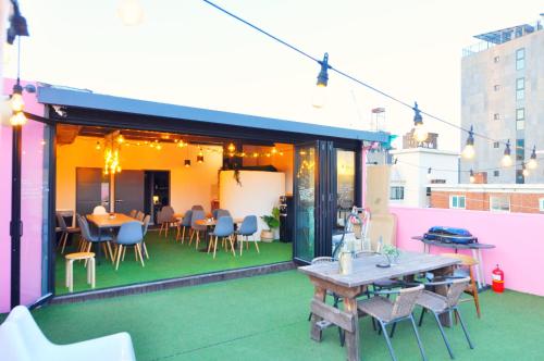 a patio with tables and chairs on a building at OYO Hostel Dongdaemun1 in Seoul