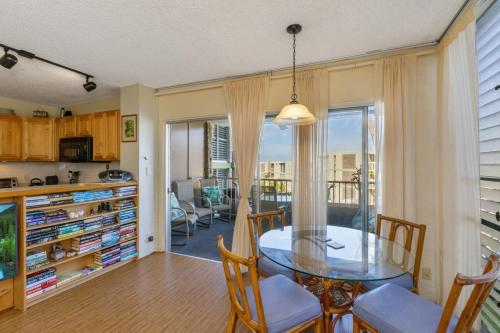 a kitchen and dining room with a glass table and chairs at Alii Villas Condominiums in Kailua-Kona