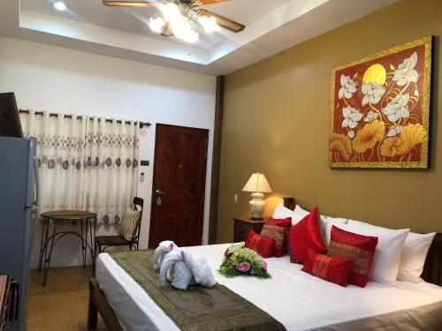 a bedroom with a bed with stuffed animals on it at On The Mekong Resort in Luang Prabang