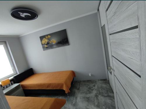 a bedroom with a bed and a door in it at Apartament Heaven in Ełk