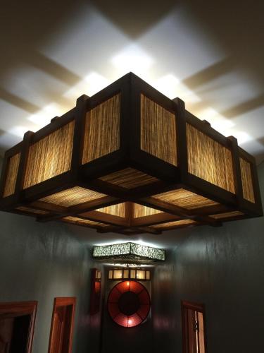 a chandelier hanging from the ceiling of a room at On The Mekong Resort in Luang Prabang