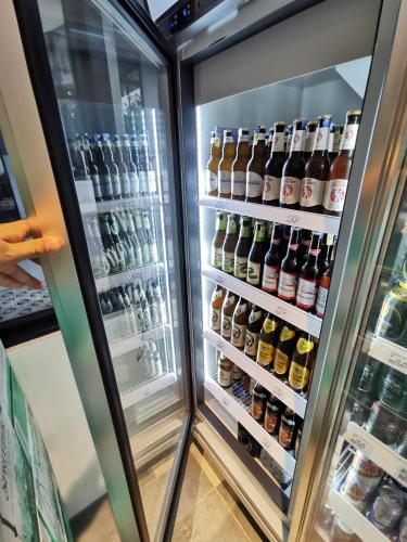 a refrigerator filled with lots of bottles of beer at Expressionz Suites By iHost Global in Kuala Lumpur