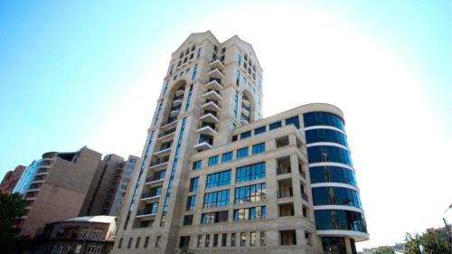 a tall building with blue windows in a city at Rooftop Apart-Hotel in Yerevan