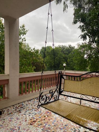 a swing on the porch of a house at Ladakh House- 3 BHK Ladakh themed Villa near Matheran in Neral