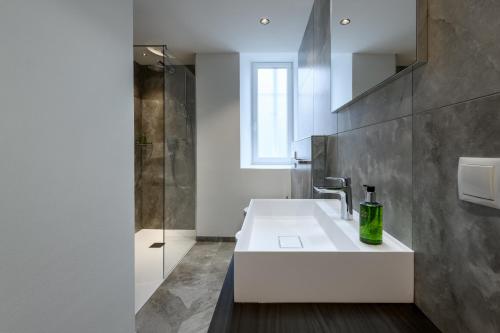a bathroom with a white sink and a shower at Villa Fauster Pustrabase in Villabassa