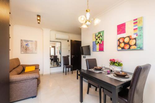 a living room with a table and a couch at Neo in Cala Ratjada