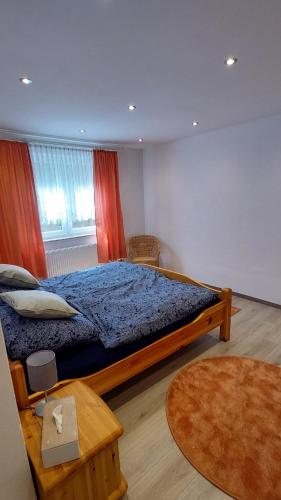 a bedroom with a large bed with a blue comforter at Ferienwohnung Fovere in Kall