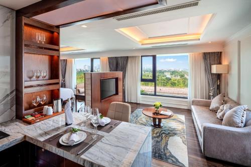 a living room with a couch and a table at Ravatel Luxury Hotel Bac Giang in Bắc Giang