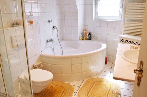 a bathroom with a tub and a toilet and a sink at Apartment in Euskirchen in Euskirchen