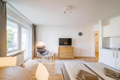 TV a/nebo společenská místnost v ubytování Glück Auf Appartements Rüttenscheiderstraße Essen
