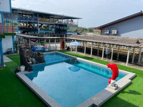 a large swimming pool in front of a building at Awangan Palace in Kuantan