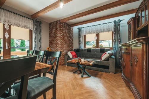 a living room with a couch and a table at Toporowe Izby in Groń