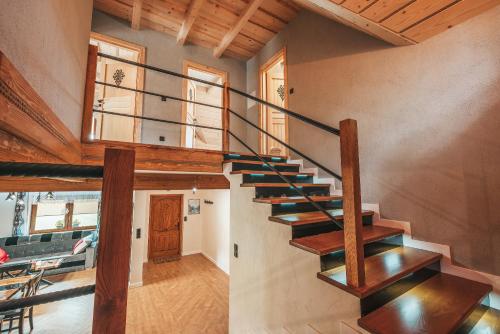 a spiral staircase in a house with a living room at Toporowe Izby in Groń