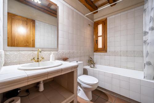 a bathroom with a sink and a toilet and a tub at El Clos 2 in Conesa