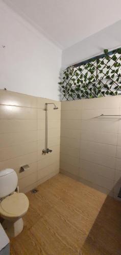 a bathroom with a toilet and a shower at Stairway to Heaven in Murree