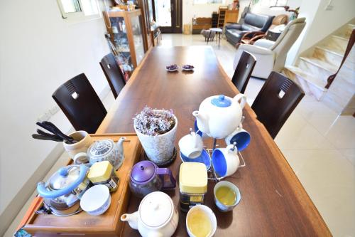 a wooden table with a tea set on it at Serenity Moutainview Homestay in Meinong