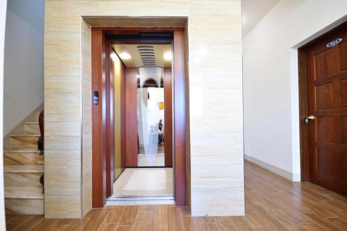 a hallway with a mirror on the wall at Serenity Moutainview Homestay in Meinong