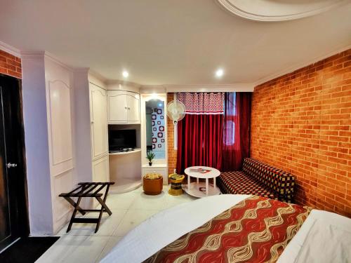 a room with a bed and a brick wall at Auckland Hotel and Restaurant Near Mall Road in Shimla